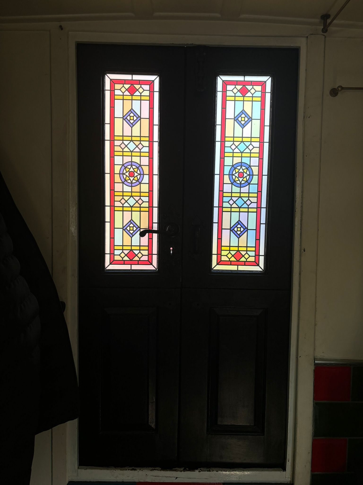 barbara stained glass film installed on a door with light behind..jpg